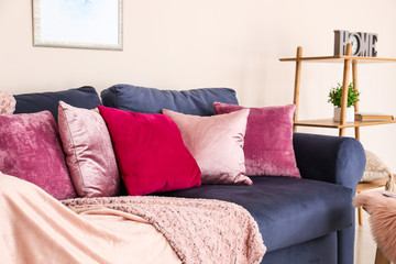 Sofa with soft pillows in modern room