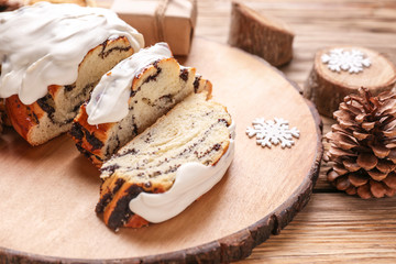 Tasty cut poppy pastry and Christmas decor on table