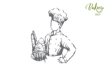 Young cook holding basket with delicious baking, baguette and long loaf, bakehouse staff, bakery employee