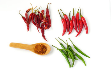 Top view Red Green Dried chili pepper and Cayenne pepper in wooden spoon isolated on white background