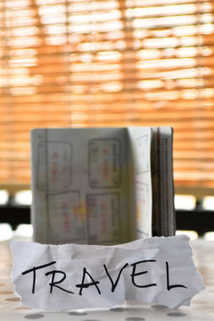 Travel note and open passport with stamps with a copy space