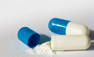 macro view of blue Capsule with white powder