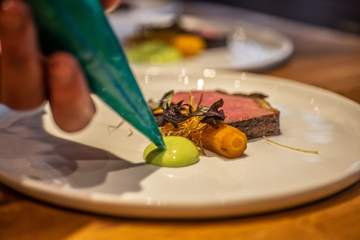 Chef plating steak dinner