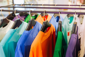clothing store stands colored shirts hangers