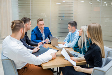 Fototapeta premium team of young professionals men and women at work in the office