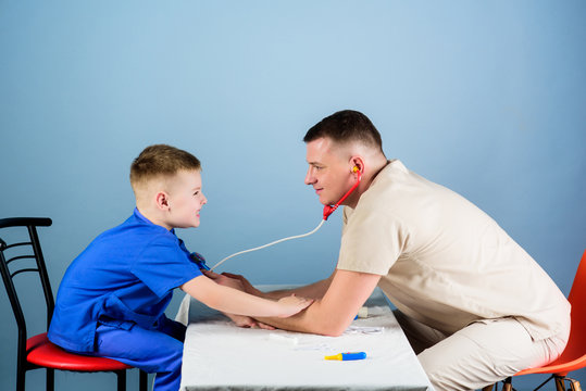 Professional Talk. Medicine And Health. Small Boy With Dad Play. Future Career. Nurse Laboratory Assistant. Family Doctor. Happy Child With Father With Stethoscope. Father And Son In Medical Uniform