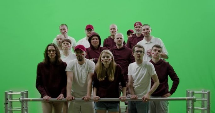 GREEN SCREEN CHROMA KEY Front view group of people fans wearing red clothes are outraged during a sport event. 4K UHD ProRes 422 HQ