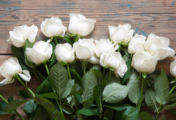 White roses on a old white wooden table