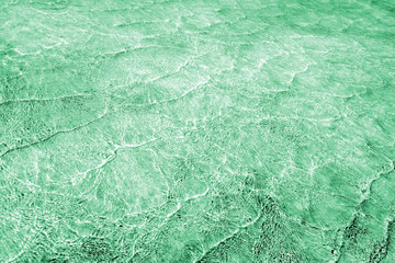 Pattern of sea waves toned in light green shades