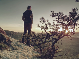 Silhouette of man thinking with hands in pocket. Hiker watch