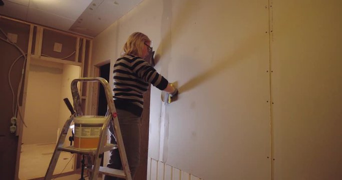 DIY women renovating and remodeling some walls, Big home improvement prodject