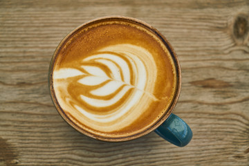 Delicious latte coffee on the wooden table