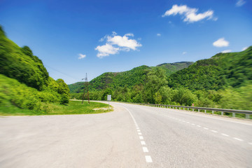 asphalt road passes through a mountain gorge