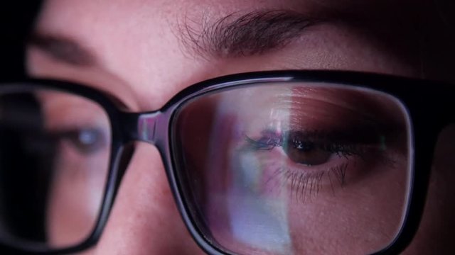 Extreme close up of woman's eyes as she scrolls through social media.