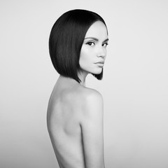 Fashion beautiful brunette with short haircut. Black and white studio portrait
