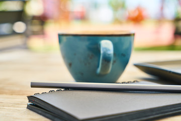 Latte coffee, cheesecake and notebook on the table
