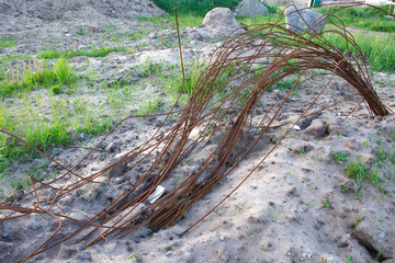 Long curved pieces of rusty reinforcement on an abandoned construction site
