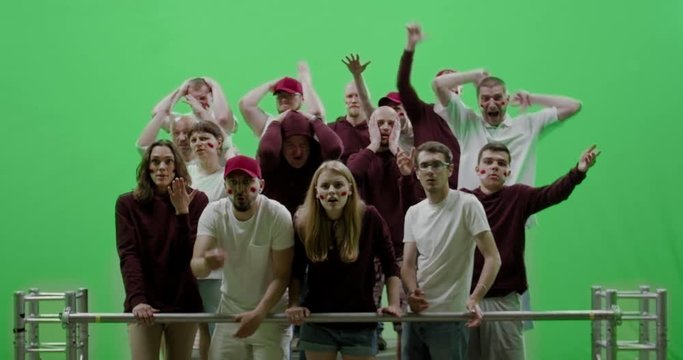 GREEN SCREEN CHROMA KEY Front view group of people fans wearing red clothes are outraged during a sport event. 4K UHD ProRes 422 HQ