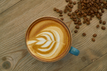 Latte coffee and coffee beans on the wooden table