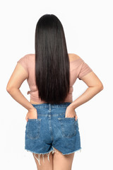 Portrait of beautiful and attractive plus size young woman  over white isolated background standing backwards; Asian woman long hair back view.
