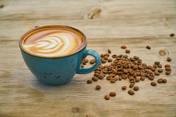 Latte coffee and coffee beans on the wooden table