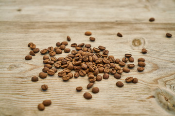 Fototapeta na wymiar Roasted coffee beans on the wooden table