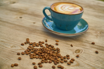 Latte coffee and coffee beans on the wooden table