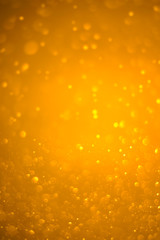 Bokeh background and bubbles reflecting yellow gold