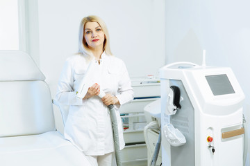 A woman tunes a laser hair removal machine