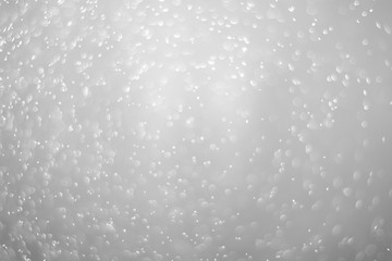 Bokeh background and bubbles reflecting black and white light