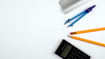 Minimal work space, flat lay photo of workspace desk. Top view office desk with pencil, circus and calculator on white color background. Panoramic banner background with copy space