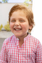 Happy child with pink shirt in the garden