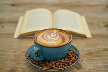 Latte coffee, coffee beans and book
