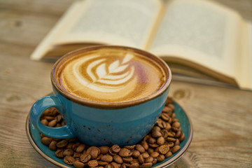 Latte coffee, coffee beans and book