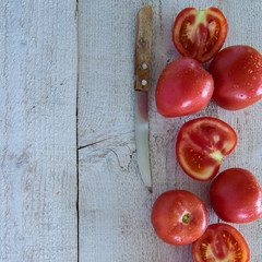 Top view of raw garden tomatoes. Wooden background, space for text
