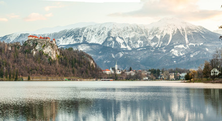 BLED, SLOVENIA - MARCH 20, 2019: Colourful spring scene on the Bled lake with medieval castle Blejski grad. Morning in Julian Slovenia, Europe.