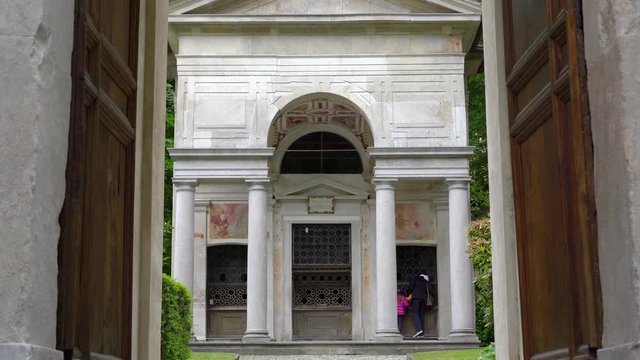 A mother and her little daughter carrying a teddy bear visiting the sacred mountain of Varallo christian devotional complex, a unesco world heritage site near the town of Varallo Sesia in Italy