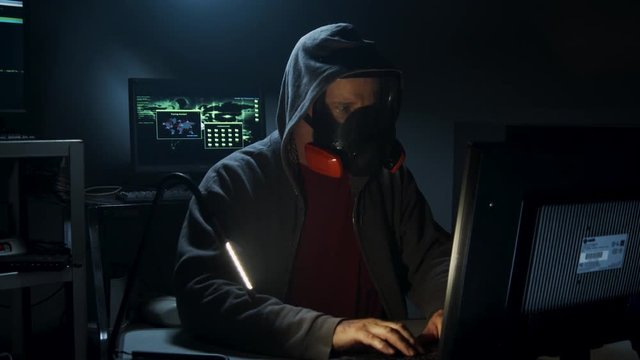 Bio-Terrorist types in computer code wearing a gas mask.