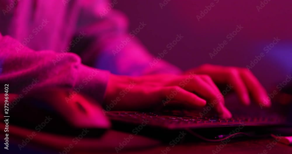 Aufkleber person typing and possible hacking a system in an alarming red and blue room. shot in 4k slowmotion.