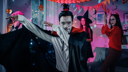 Halloween Monster Costume Party: Vampire Count Dracula wearing His Cape Does Funny Dance, In the...