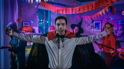 Halloween Costume Party: Count Dracula wearing His Cape Does Doing Vampire Dance, In the Background...