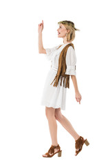 side view of cheerful hippie girl dancing isolated on white