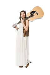 full length view of smiling pregnant hippie woman holding acoustic guitar isolated on white