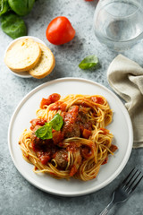 Pasta with meatballs, tomato sauce and basil