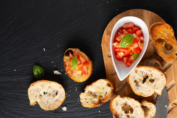 Fototapeta na wymiar Healthy food concept homemade organic vegan Tomatoes Bruschetta with roasted baguette with copy space