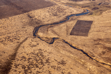 Earth from a height of flight. Aerial view of a large river and smaller tributaries.