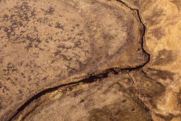Earth from a height of flight. Aerial view of a large river and smaller tributaries.