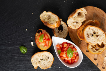 Healthy food concept homemade organic vegan Tomatoes Bruschetta with roasted baguette with copy space