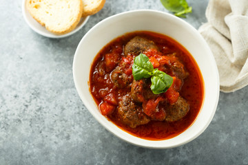 Homemade meatballs with tomato sauce and fresh basil