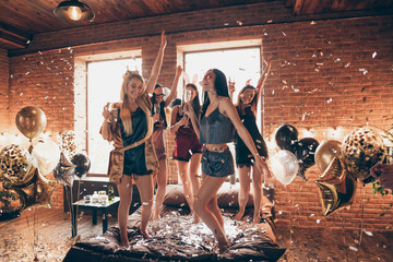 Full length body size view of nice attractive feminine lovely royal cheerful group having fun dancing on bed birthday in open space golden decorated loft industrial style interior room